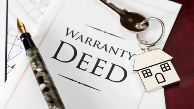 A warranty deed with a pen and house keys